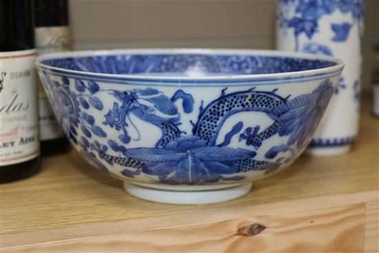 Two Chinese blue and white bowls and a famille rose bowl, 18th/19th century (3) Diameter 23cm